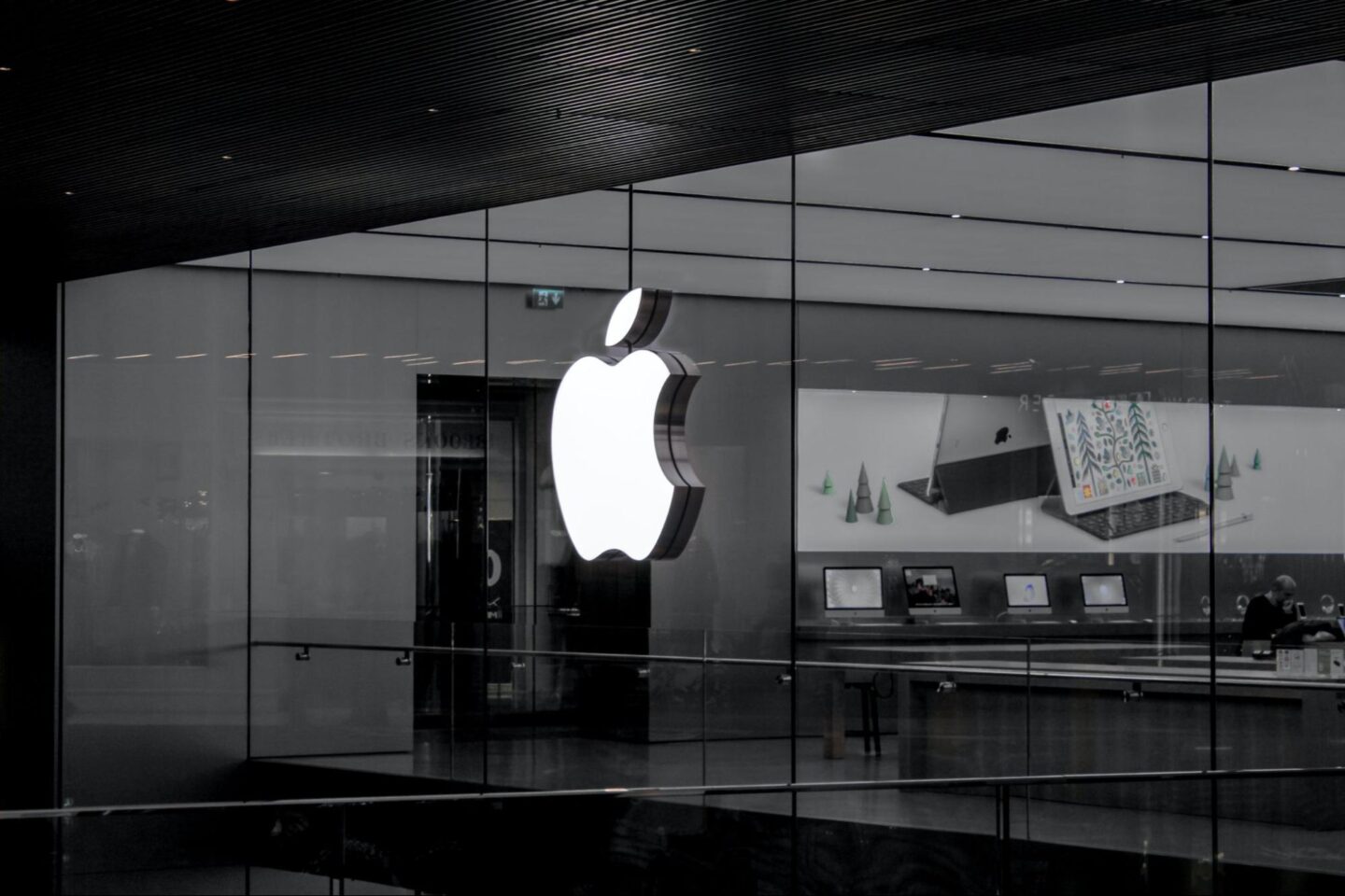 black and white photo of the outside of an apple store