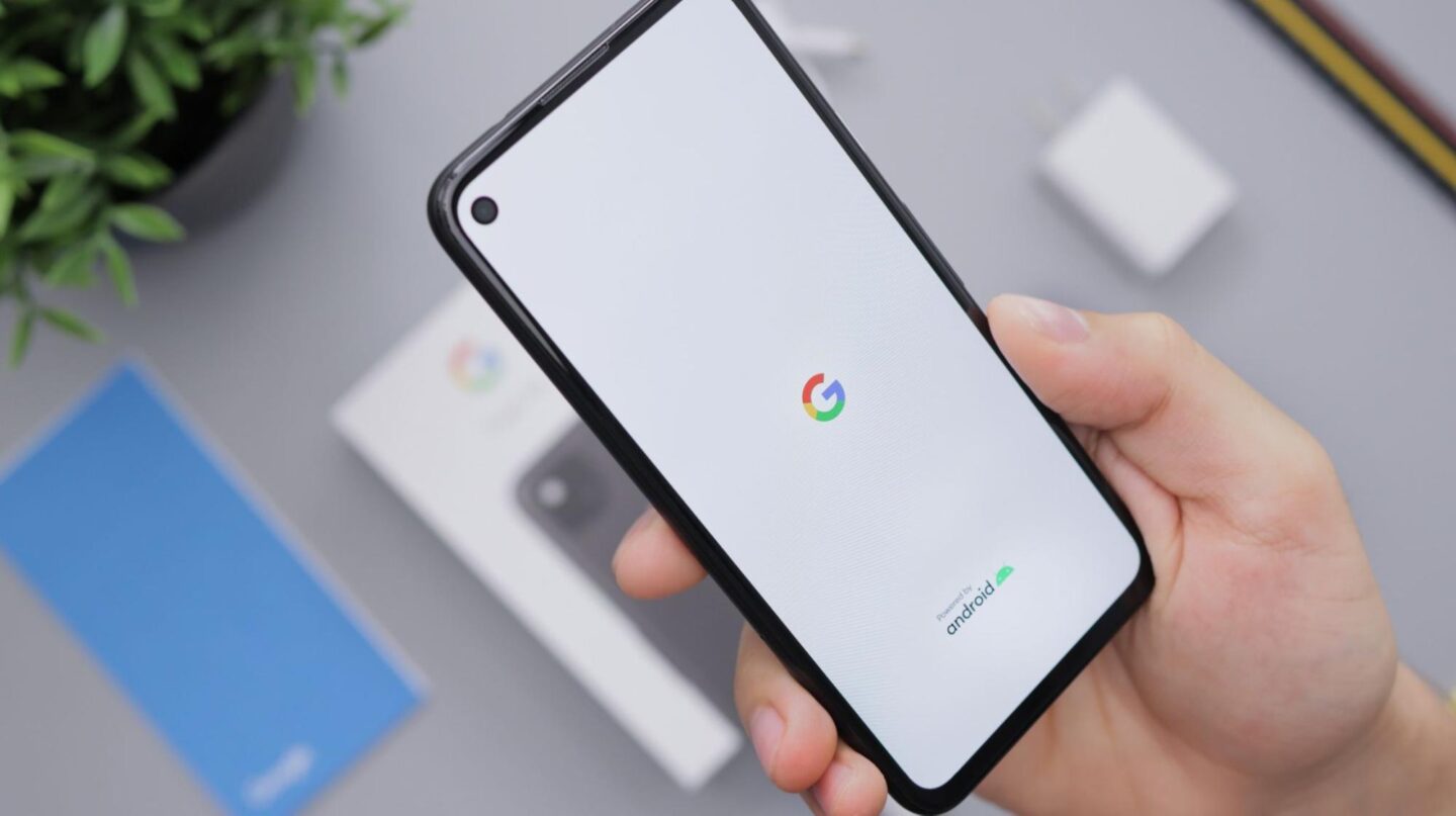 someone holding a Google Pixel 5a