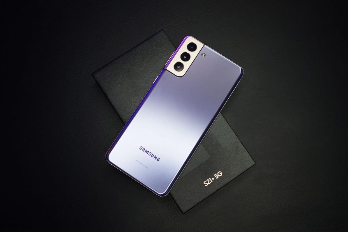 purple s21+5g Samsung phone on a black background