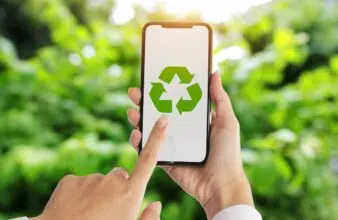 person holding a phone with a recycling icon on it