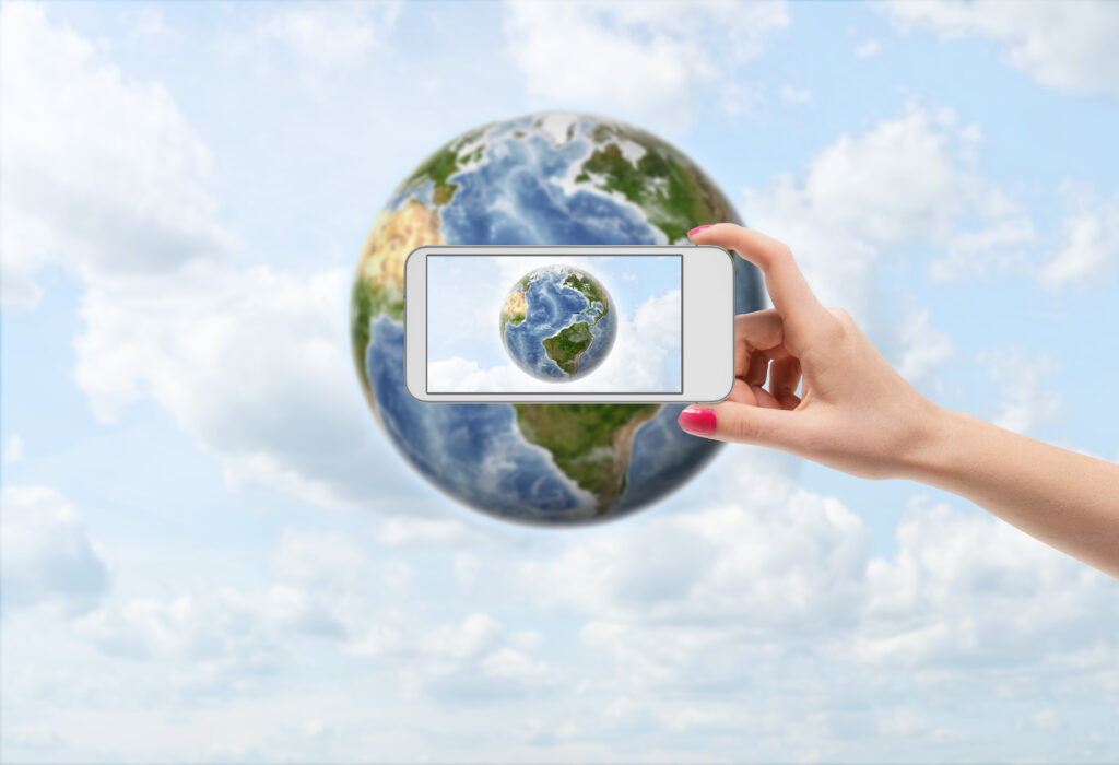 Illustration of a person taking a picture on their phone of the Earth