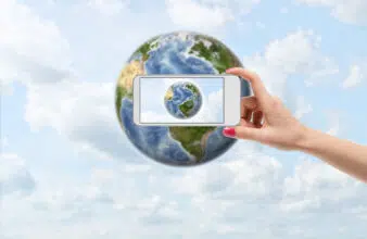 Illustration of a person taking a picture on their phone of the Earth