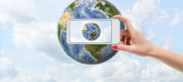 Illustration of a person taking a picture on their phone of the Earth