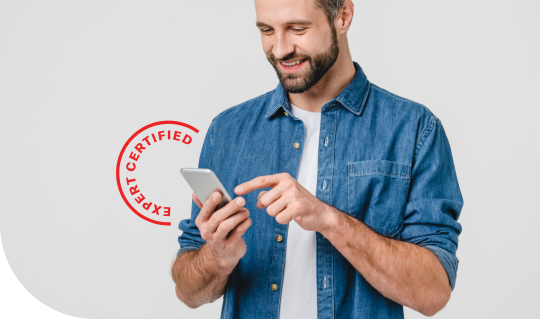 man holding a phone and smiling, he is on a simple white background and there is a red icon overlayed around the phone that says "expert certified"
