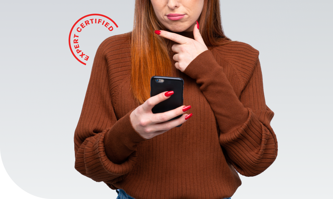 a woman holding up her iphone and frowning