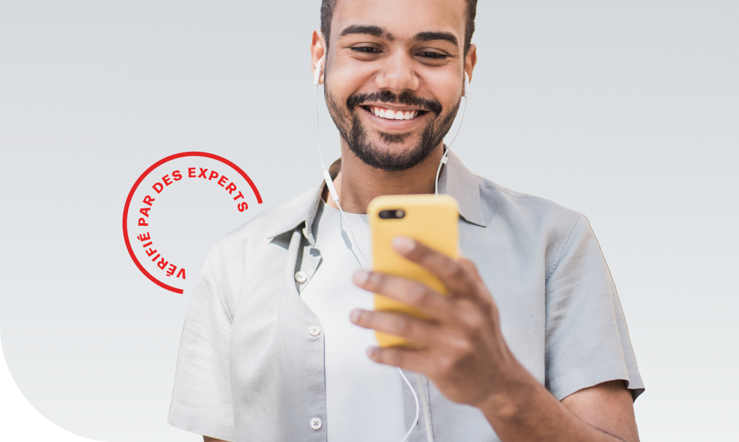 a man holding a phone with earbuds in and smiling