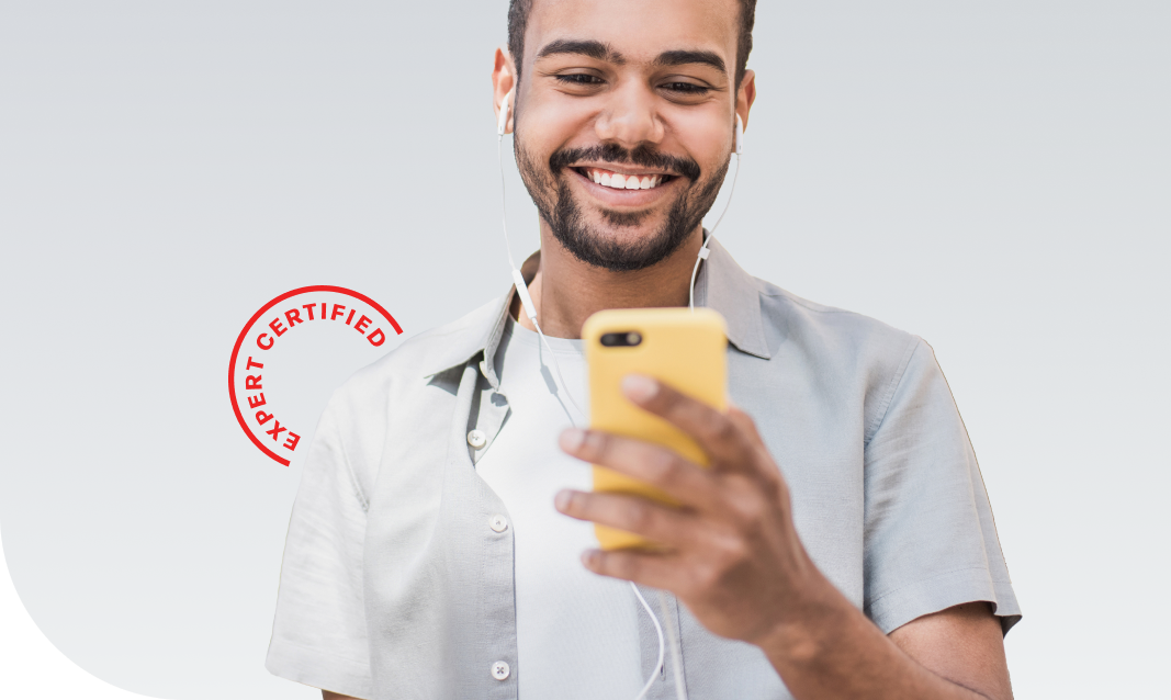 a man holding a phone with earbuds in and smiling