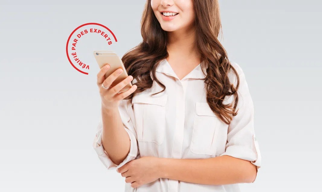A woman smiling and holding a phone with a badge on the corner that says Expert Certified