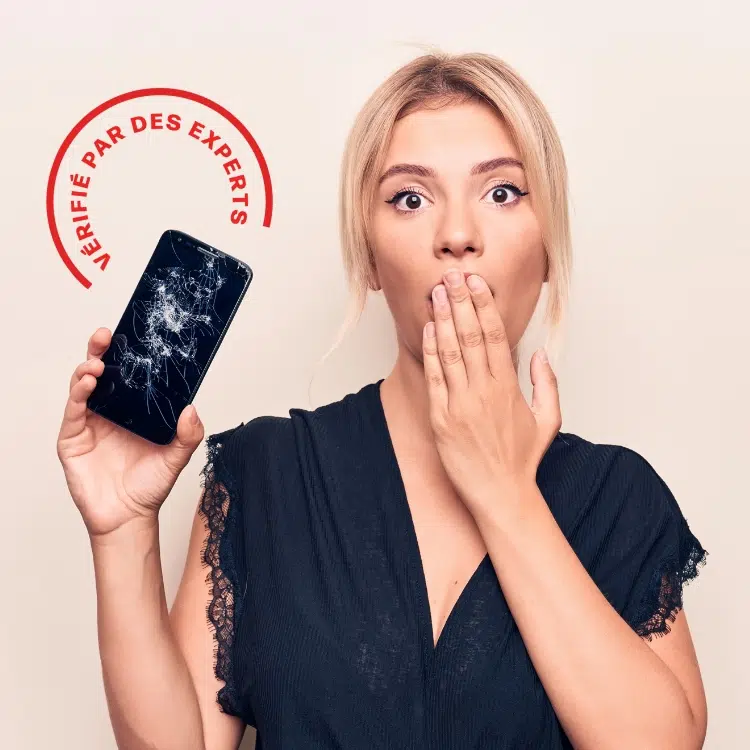 Person holding phone with a cracked screen