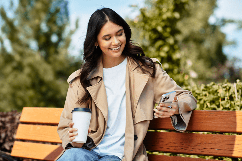 Person sitting on a bench using their phone