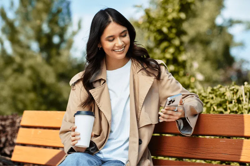 Person sitting on a bench using their phone